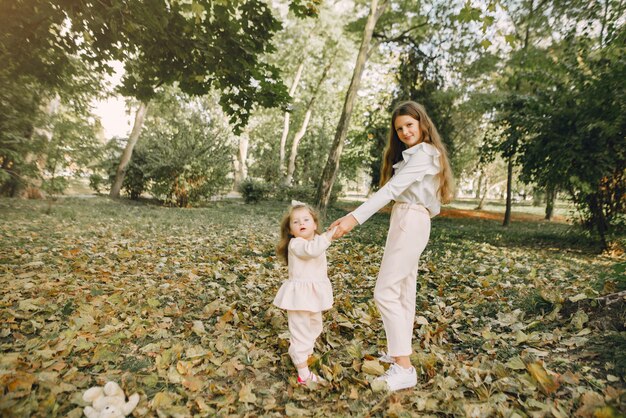 Lindas hermanitas jugando en un parque de primavera