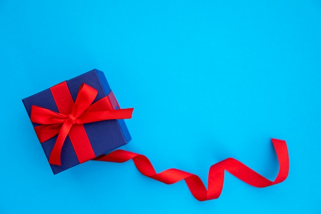 Lindo regalo azul y rojo con cinta.