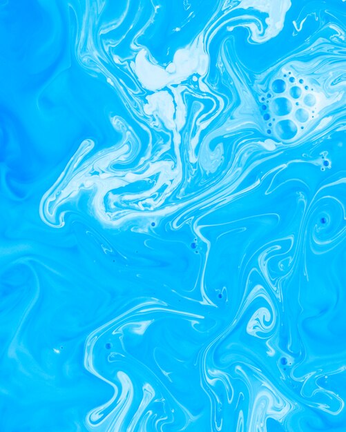 Líquido abstracto azul y blanco mezclado o pintura acrílica.
