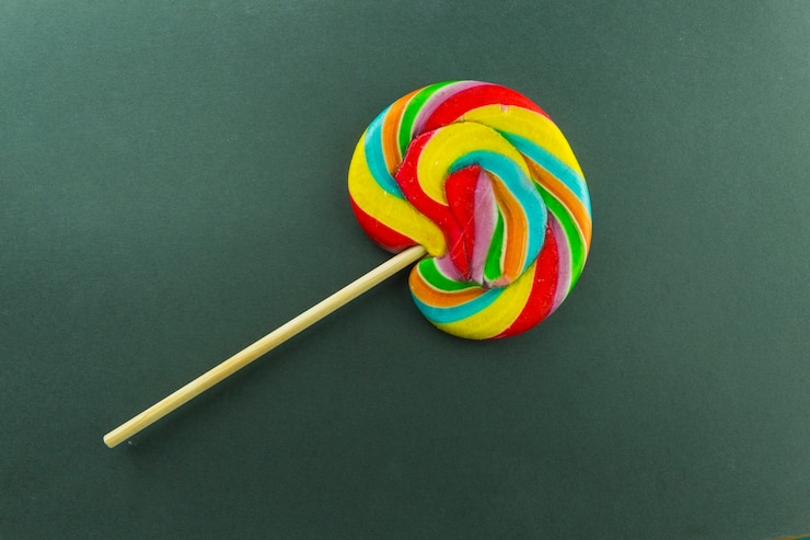 Foto gratuito lollipop colorido en verde