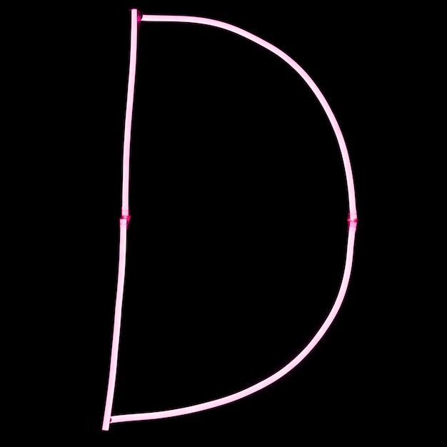 Luces de neón rosa alfabeto sobre fondo negro