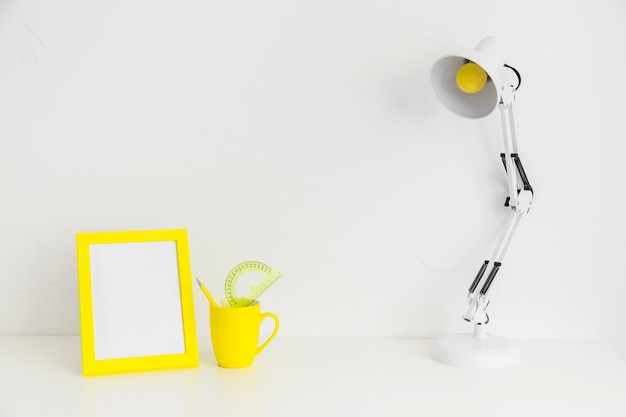 Lugar creativo minimalista para estudios con marco de fotos amarillo