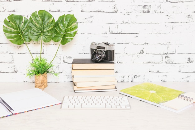 Foto gratuita lugar de trabajo creativo con libros y cámara