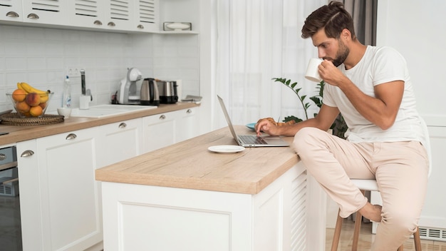 Foto gratuita macho adulto trabajando casualmente desde casa