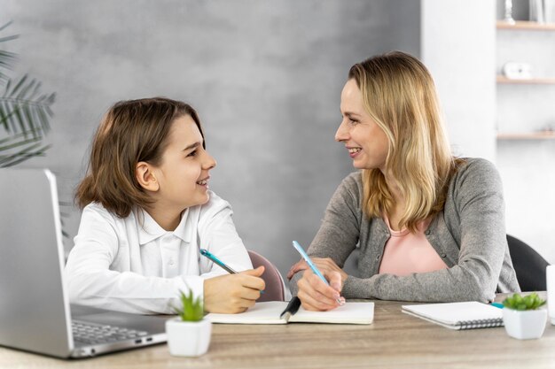 Madre ayudando a su hija a estudiar