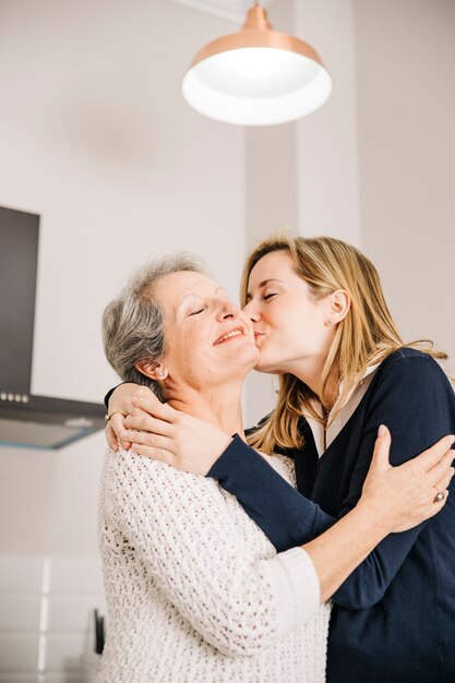 Madre besando hija en el día de la madre