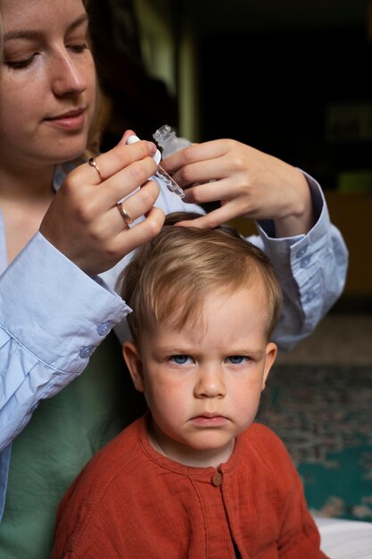 Madre cuidando a su hijo con piojos