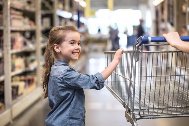 Madre e hija de compras en el supermercado eligiendo productos