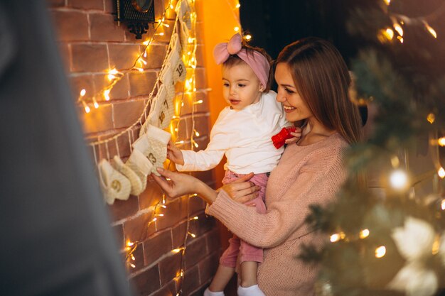 Madre e hija que decoran el hogar en Navidad