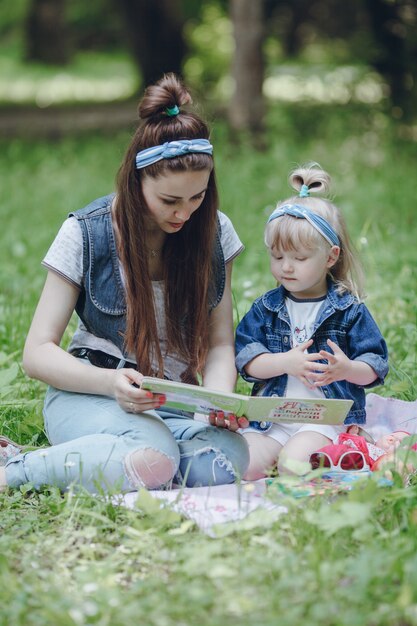 Madre e hija sentadas en el suelo leyendo un cuento