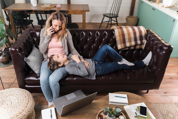 Madre e hijo descansando en el sofá