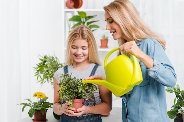 Madre e hijo regando flores