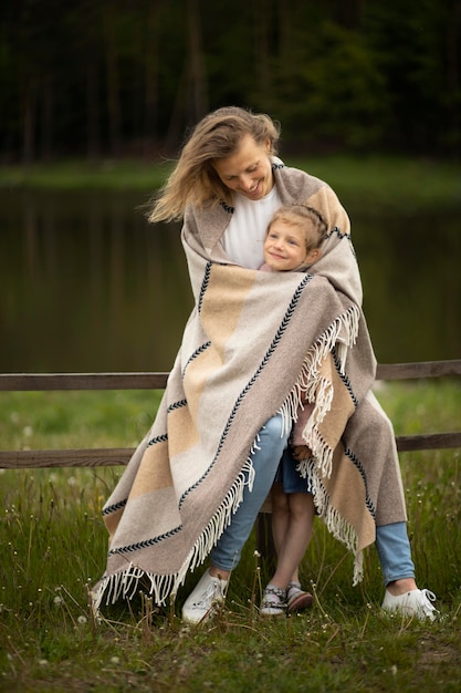 Foto gratuita madre e hijo de tiro completo con manta