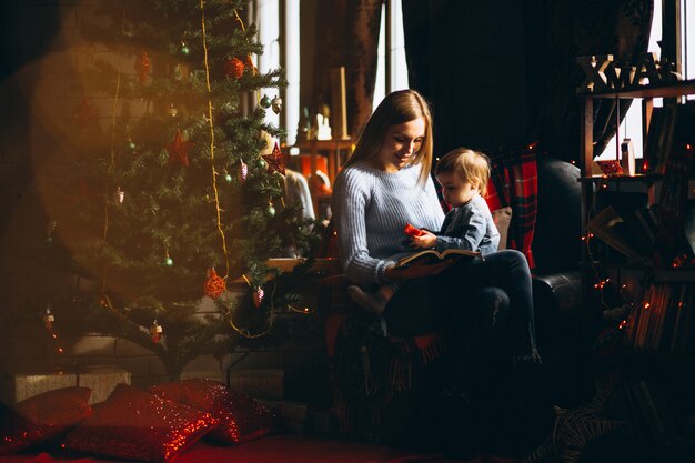 Madre con hija por arbol de navidad