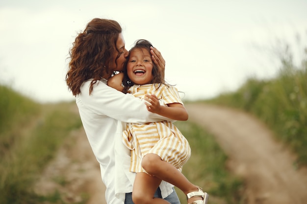 Madre con hija jugando en un campo de verano