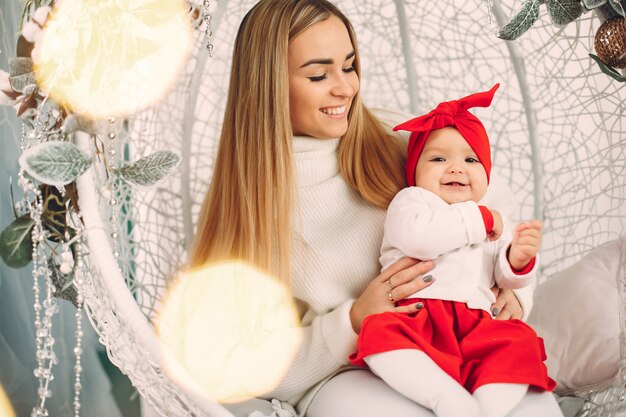 Madre con hija linda en una decoración navideña