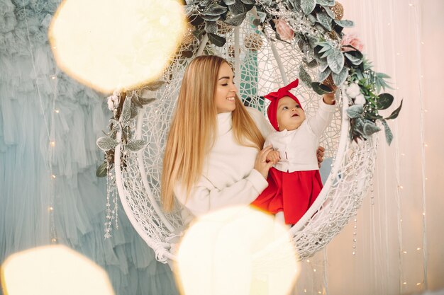 Madre con hija linda en una decoración navideña