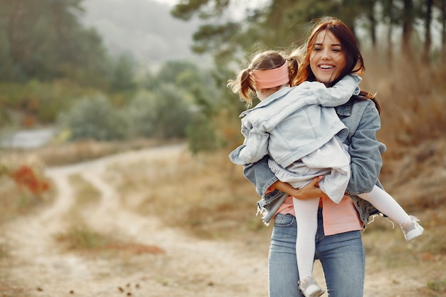 Madre con hija pequeña jugando en un campo