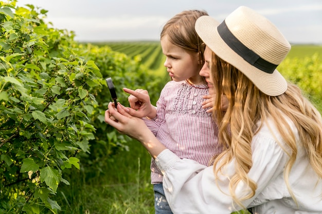 Foto gratuita madre mostrando plantas a niña