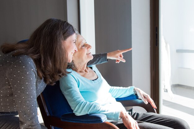 Madre positiva e hija disfrutando de vista dramática