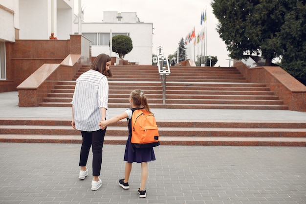 Madre prepara pequeña hija a la escuela