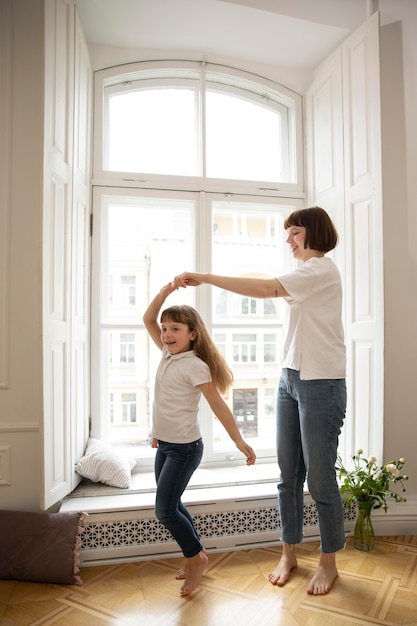 Madre de tiro completo bailando con niña