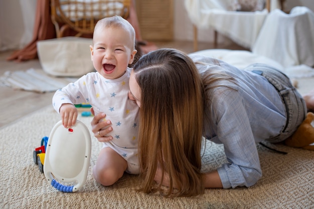 Madre de tiro completo jugando con bebé