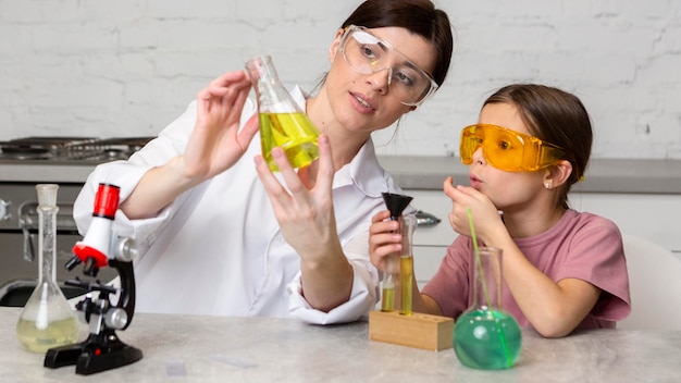 Maestra y niña haciendo experimentos científicos