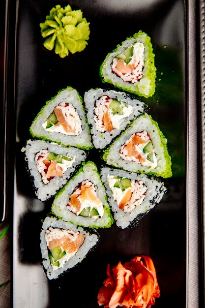 Maki con crema de salmón y cangrejo. queso arroz pepino jengibre wasabi vista superior