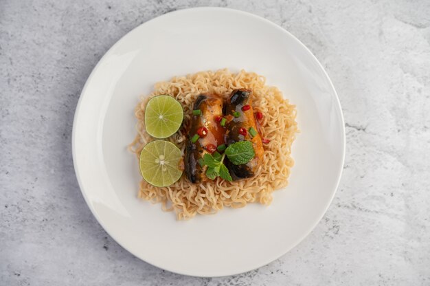 Mamá y conservas de pescado en un plato blanco.