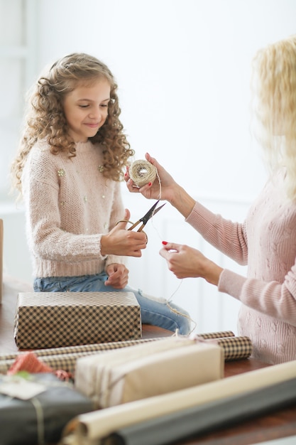 Mamá e hija envolviendo regalos