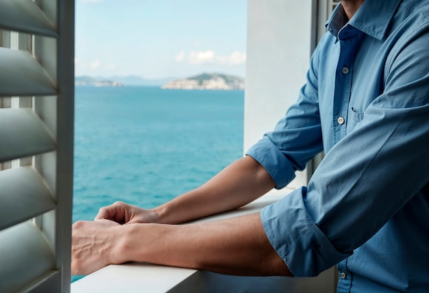 Man at balcony enjoying coastal sea view