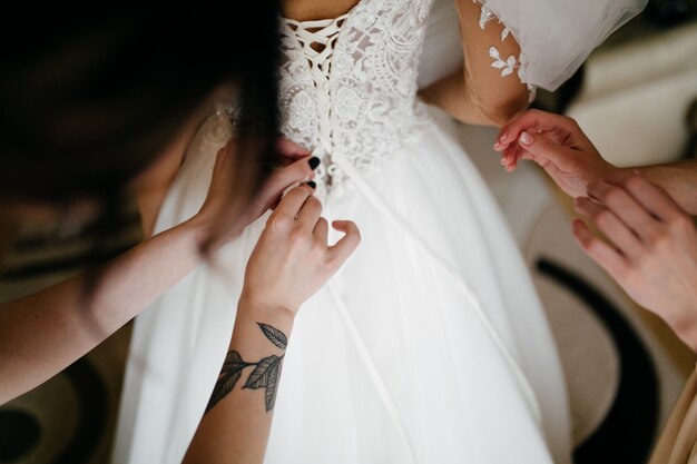 Mañana de la novia cuando ella lleva un hermoso vestido.