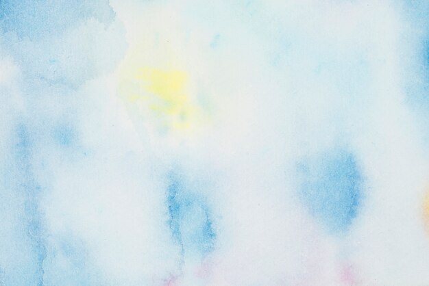 Foto gratuita manchas azules y amarillas de pinturas sobre papel blanco.