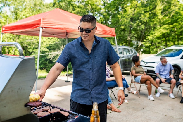 Manejando la parrilla en una fiesta en el portón trasero