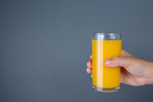 Foto gratuita mango de vidrio de jugo de naranja.