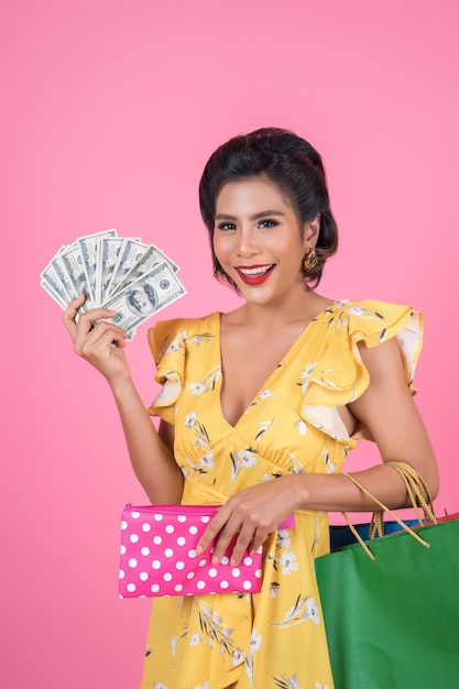 Foto gratuita mano de la mujer de la moda de los jóvenes que sostiene la cartera y los panieres