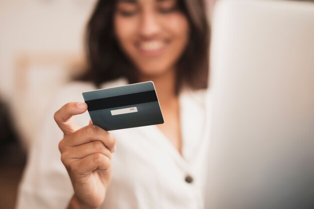 Mano de mujer sosteniendo una tarjeta de crédito