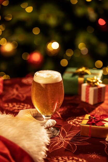 Mano sujetando navidad cerveza bodegón