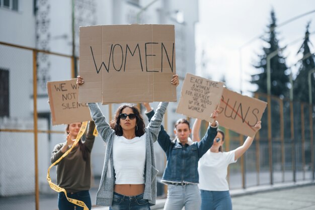 Con las manos en alto. Grupo de mujeres feministas al aire libre protesta por sus derechos