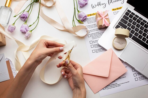 Manos femeninas creando invitaciones hechas a mano