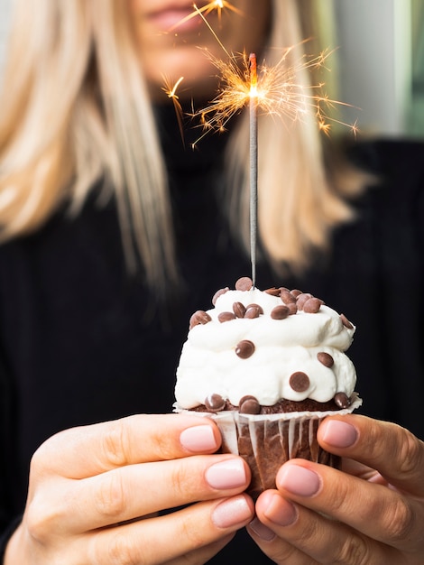 Foto gratuita manos femeninas con sabroso muffin