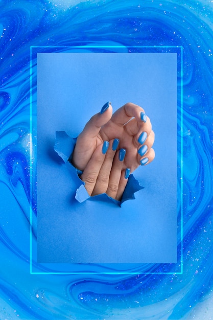 Manos con hermosas uñas azules