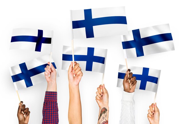 Manos ondeando banderas de Finlandia