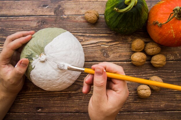 Manos pintando calabaza