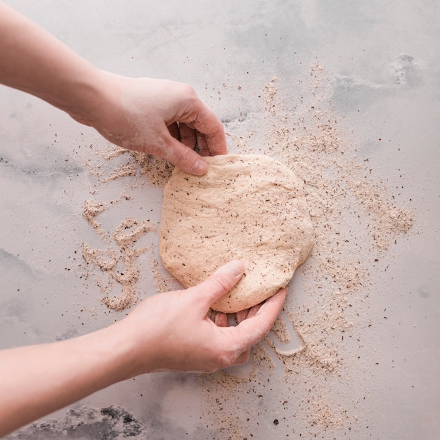 Manos de primer plano haciendo masa de pan