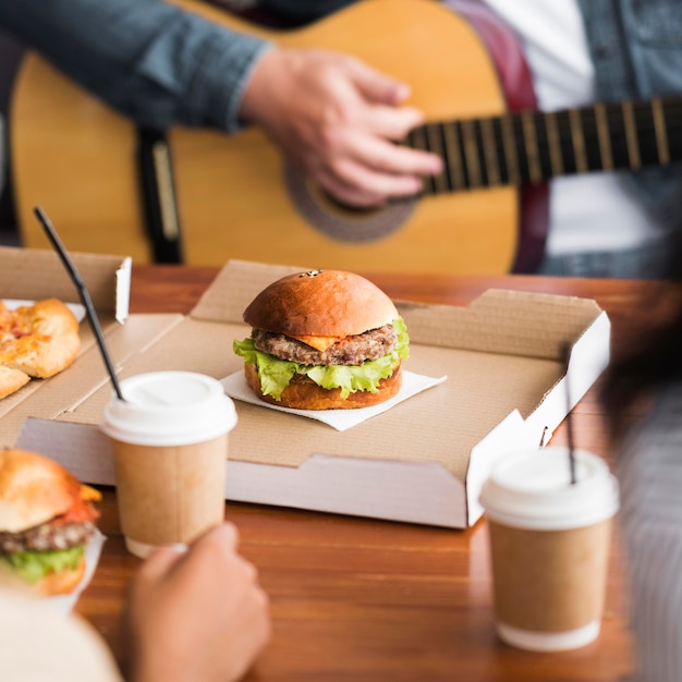 Manos de primer plano tocando la guitarra en la mesa