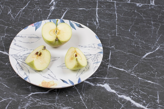 Foto gratuita manzanas verdes en rodajas en un plato colorido.