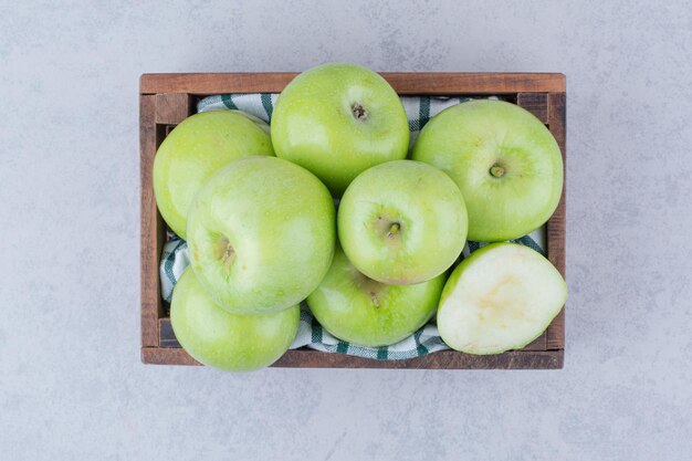 Manzanas verdes sabrosas en canasta de madera. Foto de alta calidad
