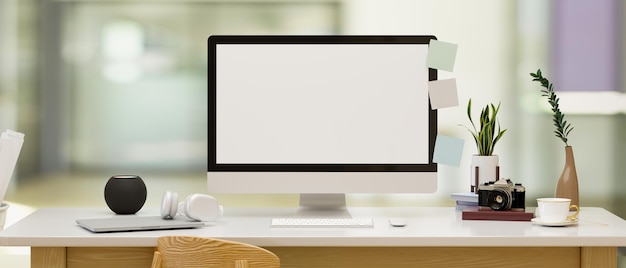 Maqueta de pantalla en blanco de la computadora de escritorio pc en una mesa sobre fondo de oficina borrosa representación 3d